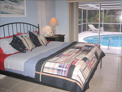 2923.vacation_homes_in_marco_island_house_rental_-_king_bed_in_master_bedroom_wmaster_bath_roll_out_of_bed_and_into_the_pool_.jpg